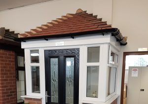 Black front door and white uPVC front porch