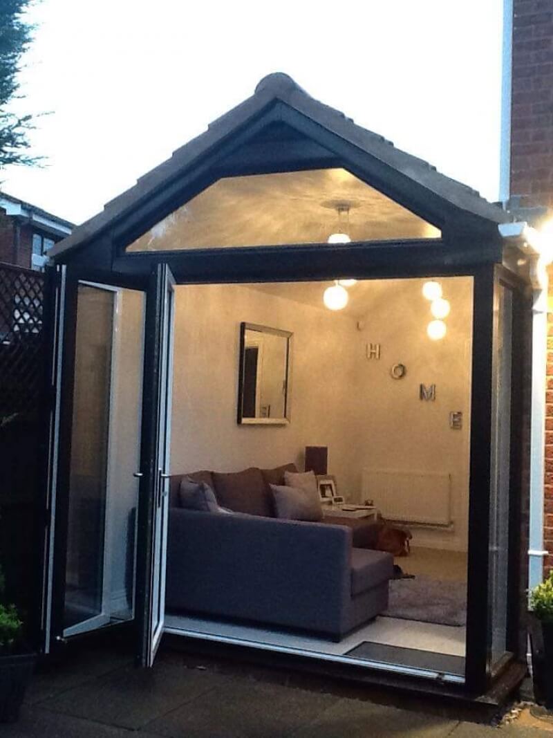 Bespoke conservatory with tiled roof and bifold door