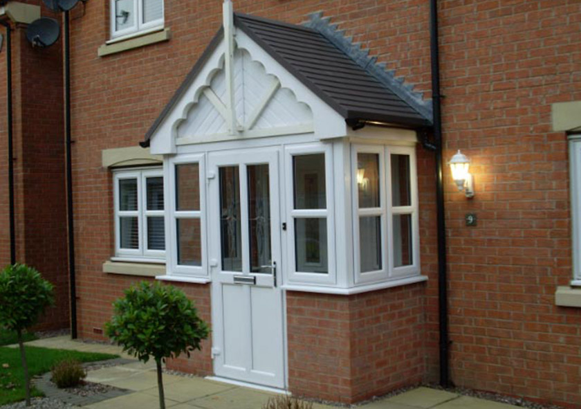 white upvc door on a brick home surrounded by upvc casement windows in sedgley